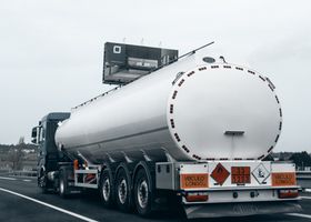 pexels photo 36228061 36228061 Rear view of a large tanker truck transporting fuel on a highway, emphasizing logistics and transportation.